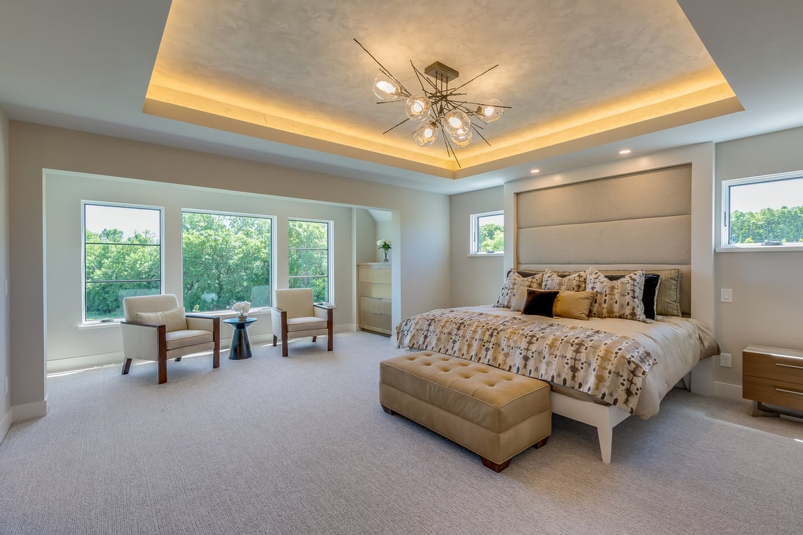 Luxurious master bedroom with coffered ceiling and LED lighting